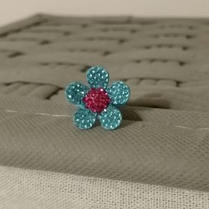 Metal and rhinestone flower ring.